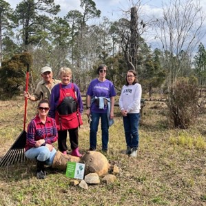 A group of people standing in a field.